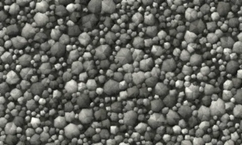 Angular grey stone of mixed sizes with fine dust filling the spaces between pieces.