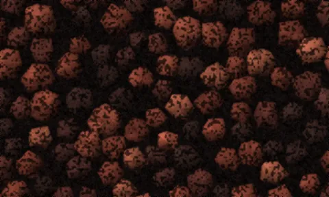 Dark red-brown lava rock, each piece pitted with small gas holes.